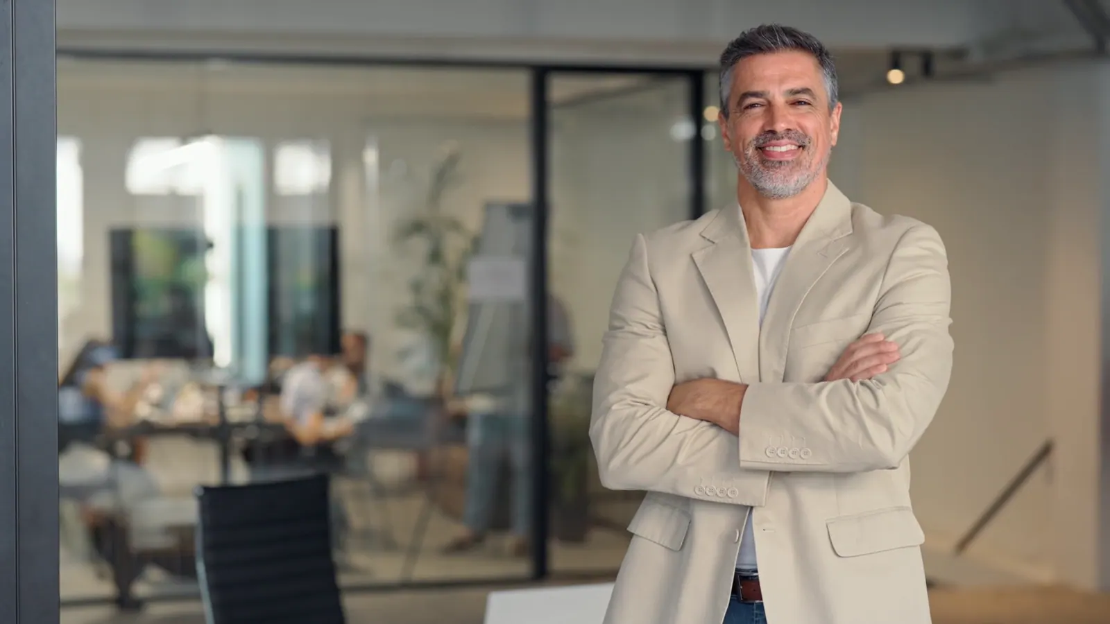 Confident businessman standing in modern office en