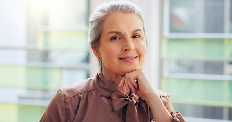 Confident senior woman posing with grey hair
