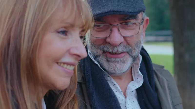 Couple smiles together in an urban park