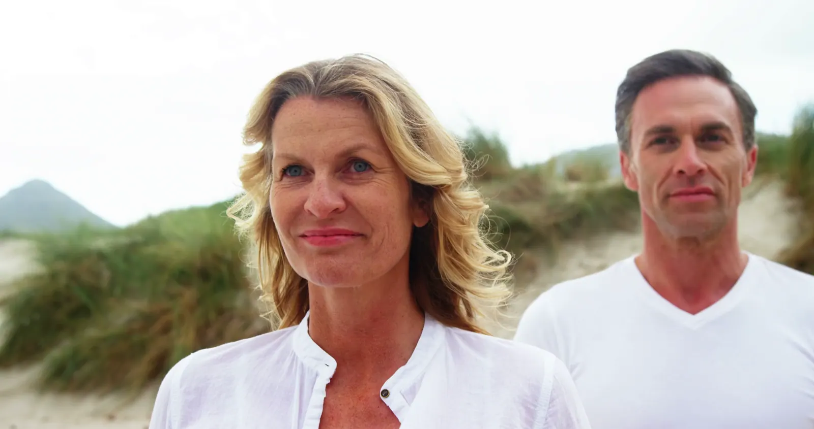 Happy couple on beach with sand and surf