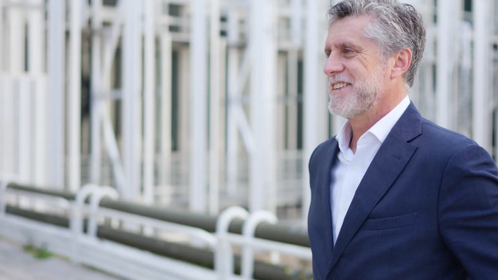 Mature man smiles confidently in business suit