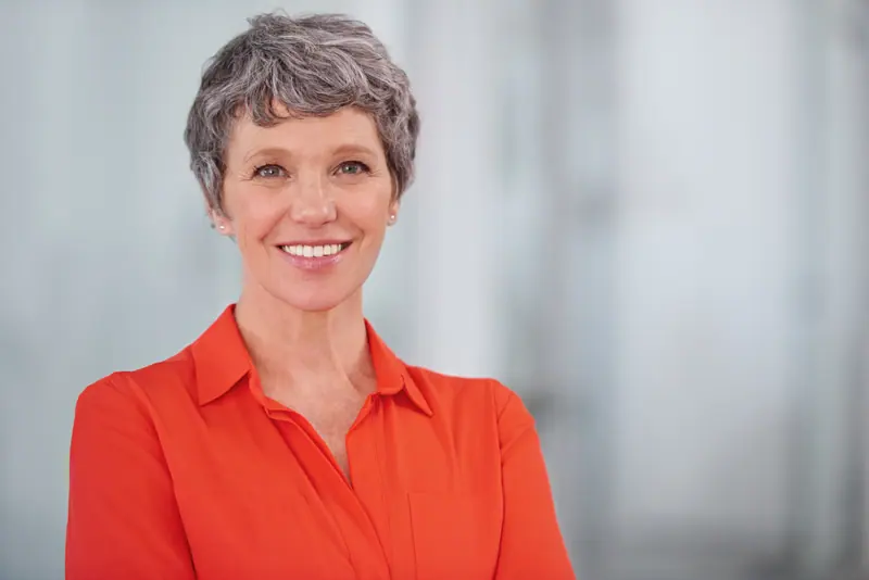 Professional woman smiling confidently in an offic