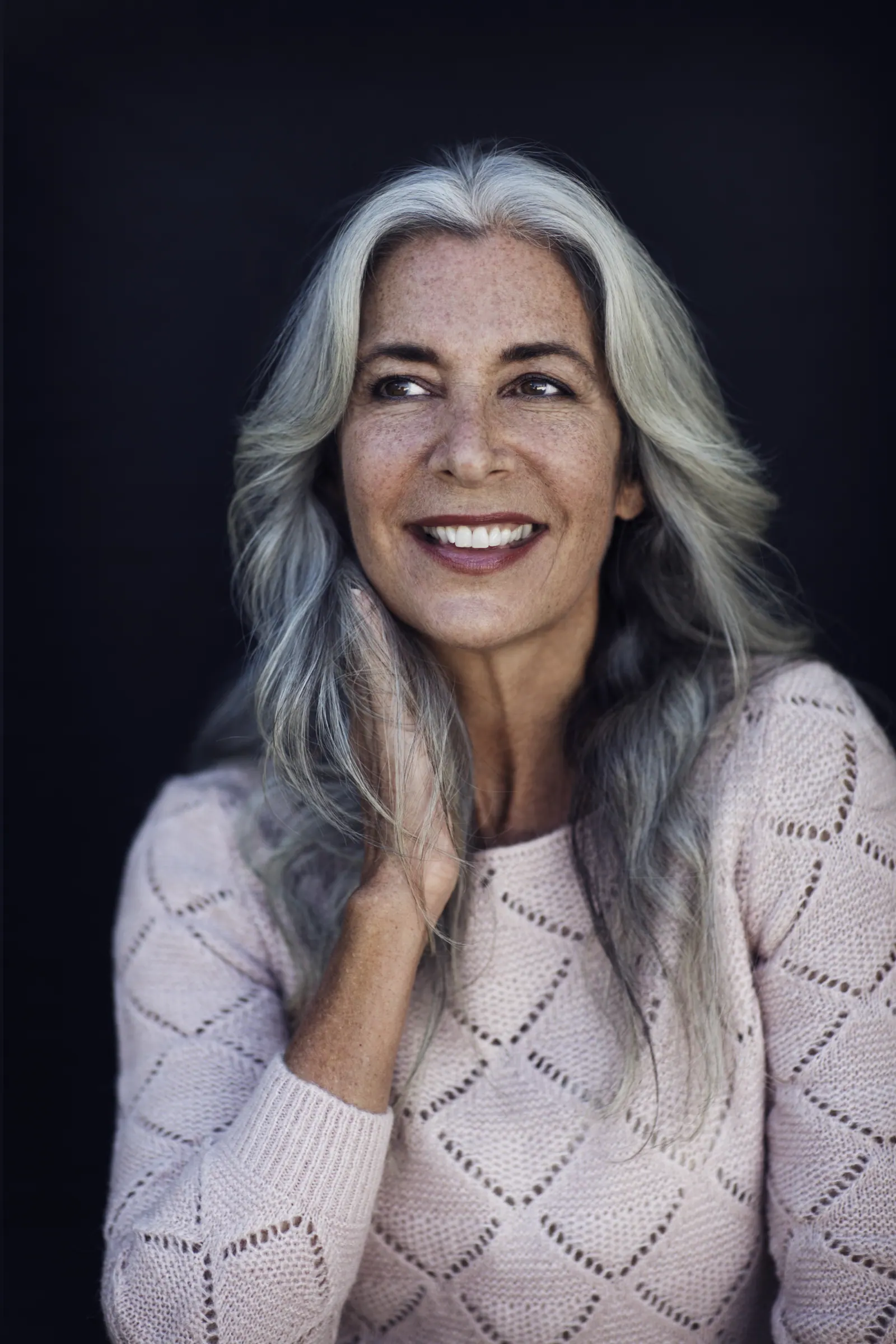 Radiant senior woman with long grey hair smiling