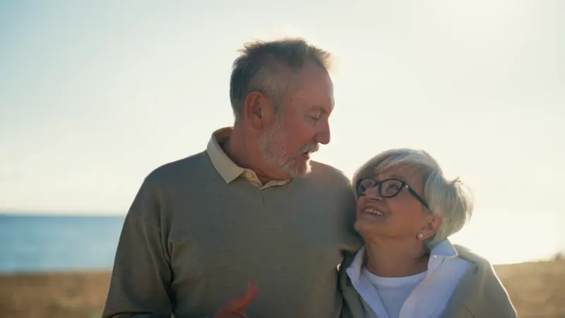 Senior couple enjoying seaside conversation