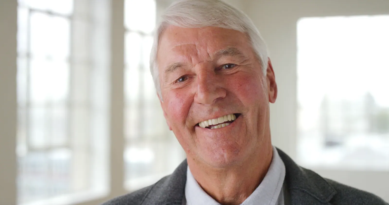 Senior man smiling close up portrait indoors