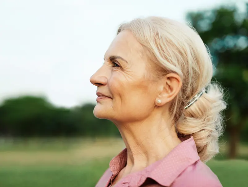 Senior woman profile with hair up outside