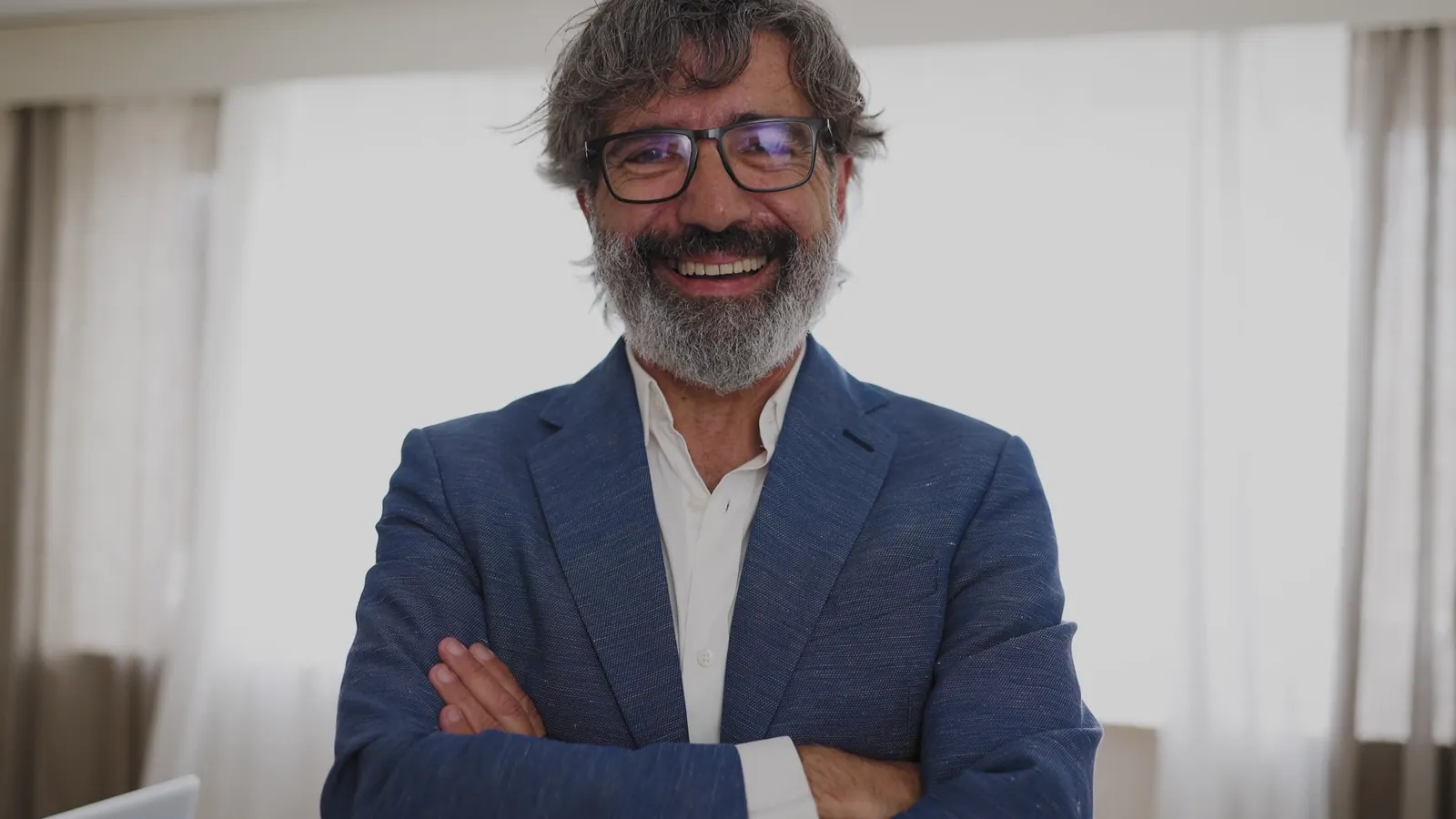Smiling confident man in blue blazer indoors