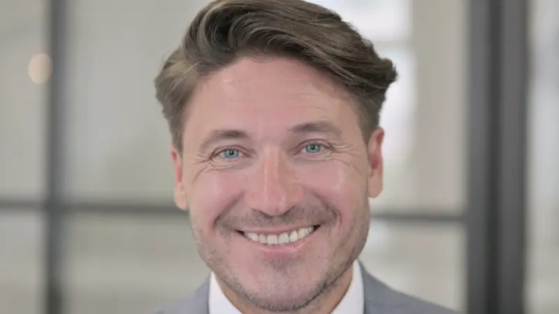 Smiling man close up portrait in gray suit