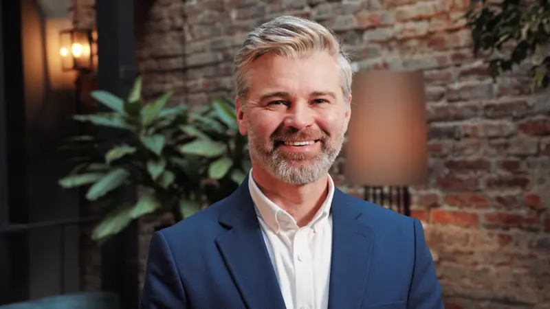 Smiling man in blue suit jacket close up