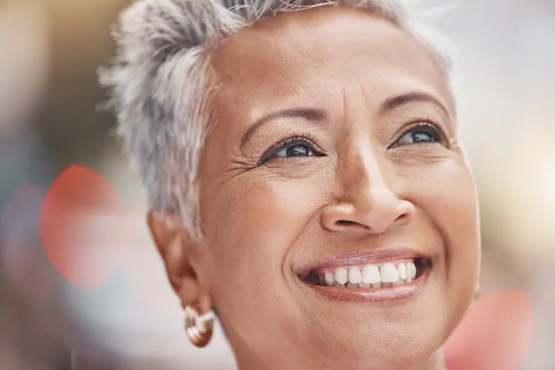 Smiling senior woman enjoys a sunny day