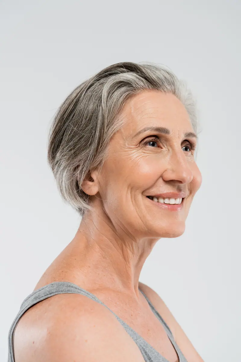 Smiling senior woman with gray hair posing