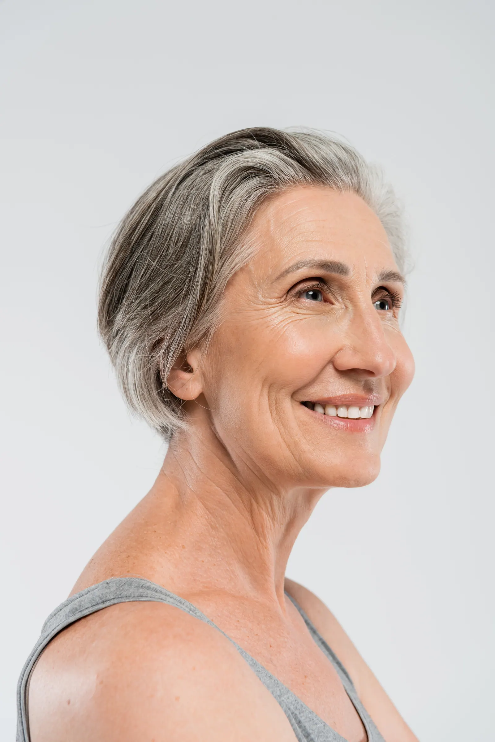 Smiling senior woman with gray hair posing