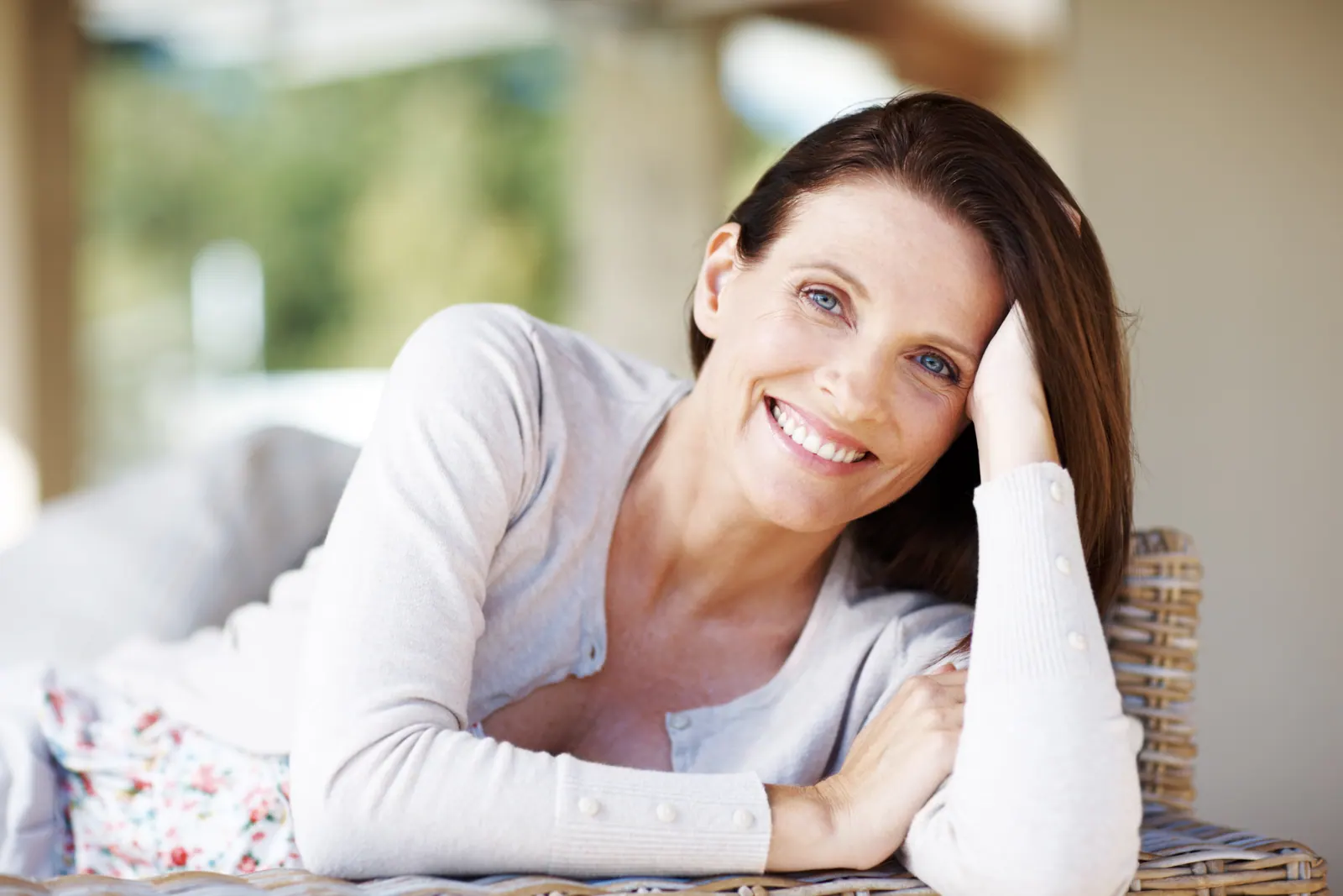 Smiling woman relaxing at home in natural light