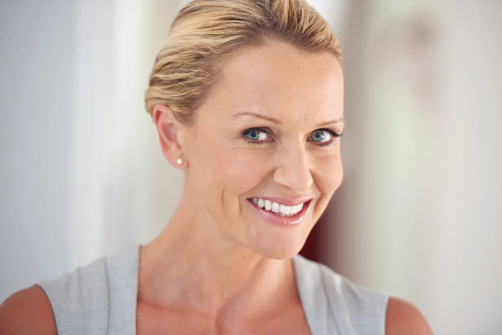 Smiling woman with blond hair close up portrait