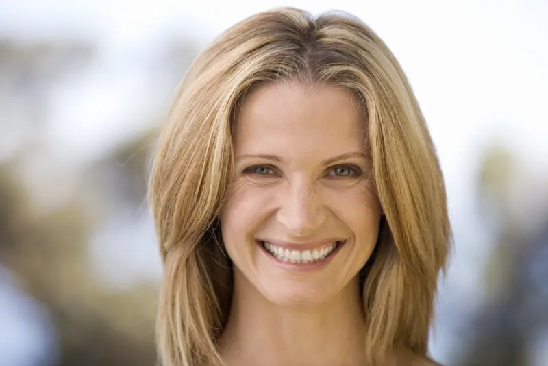 Smiling woman with long blonde hair portrait