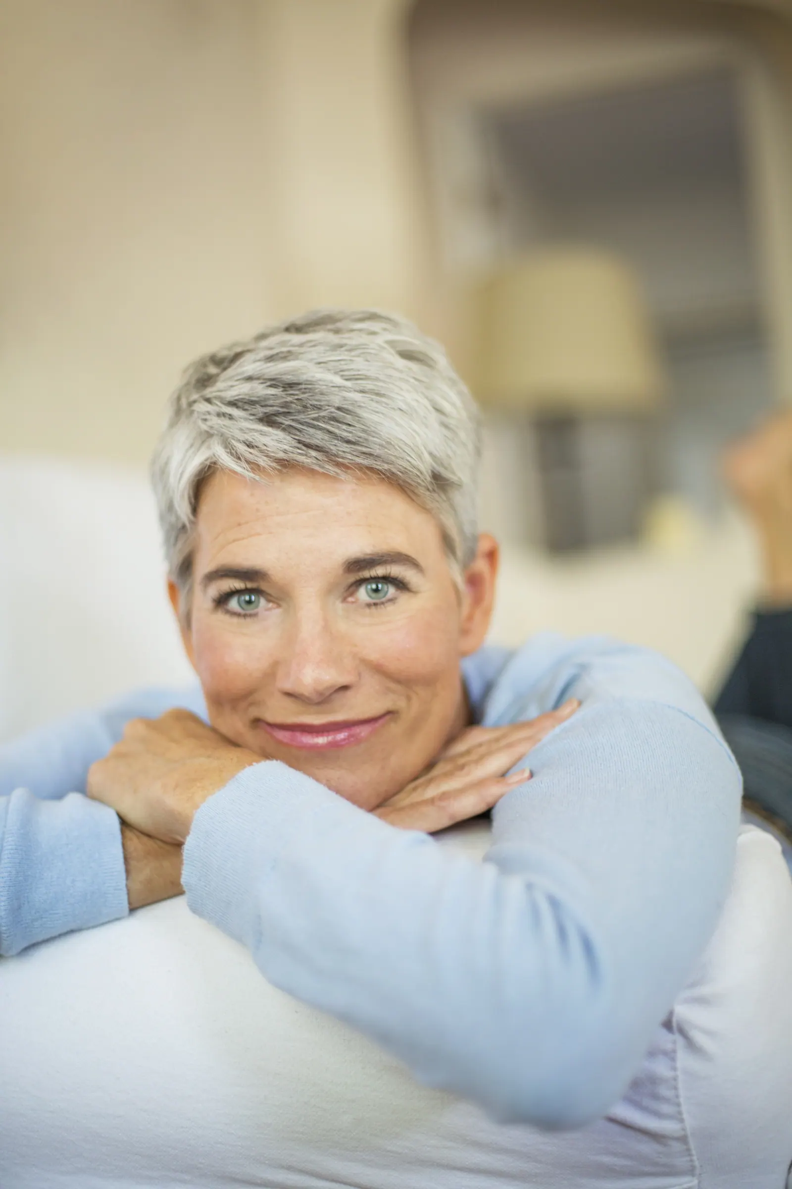 Smiling woman with short gray hair indoors