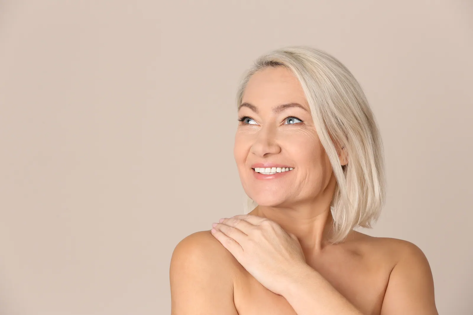 Smiling woman with white hair in studio setting