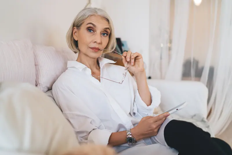 Stylish woman relaxing at home with tablet