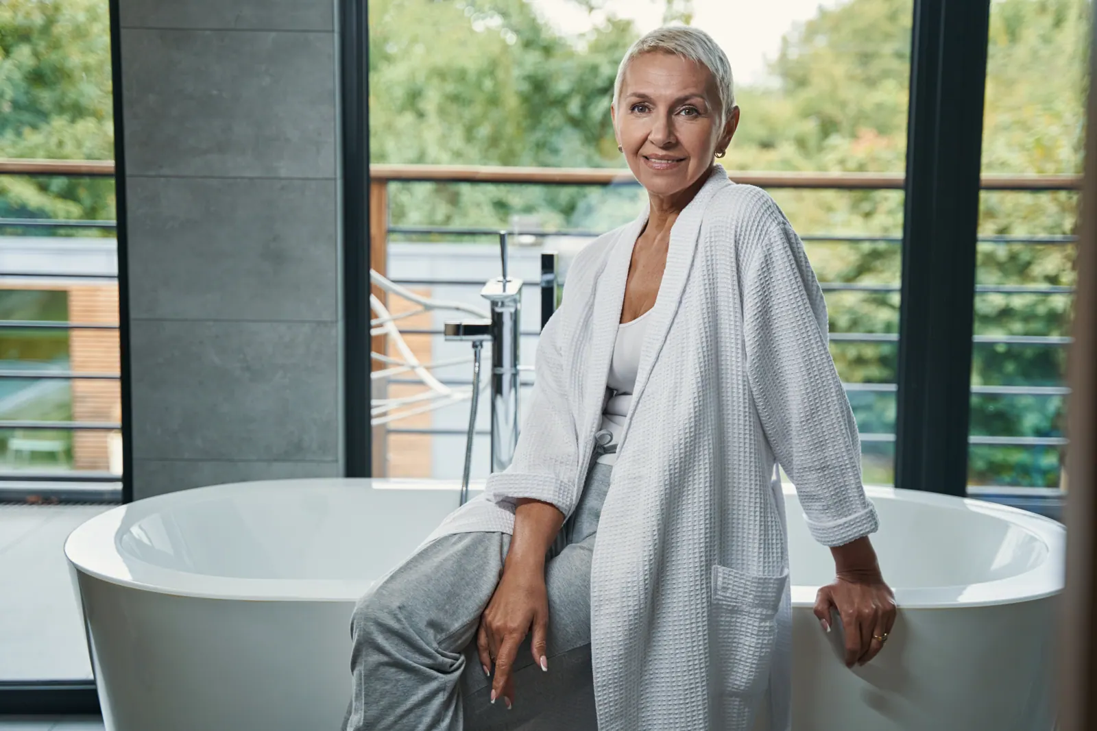 Woman relaxing in bathroom wearing robe