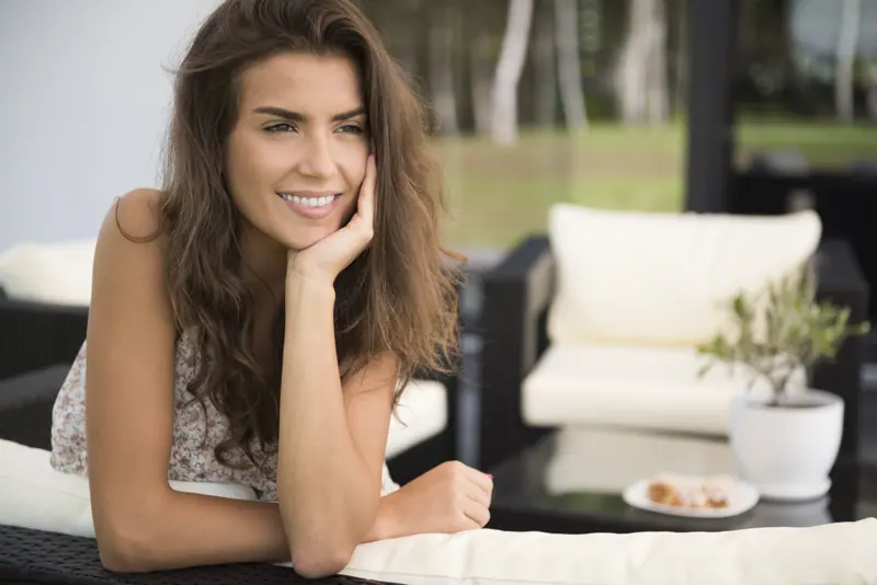 Woman relaxing on an outdoor patio chair