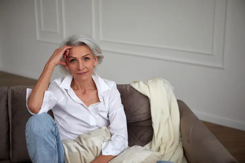 Woman relaxing on couch at home indoors