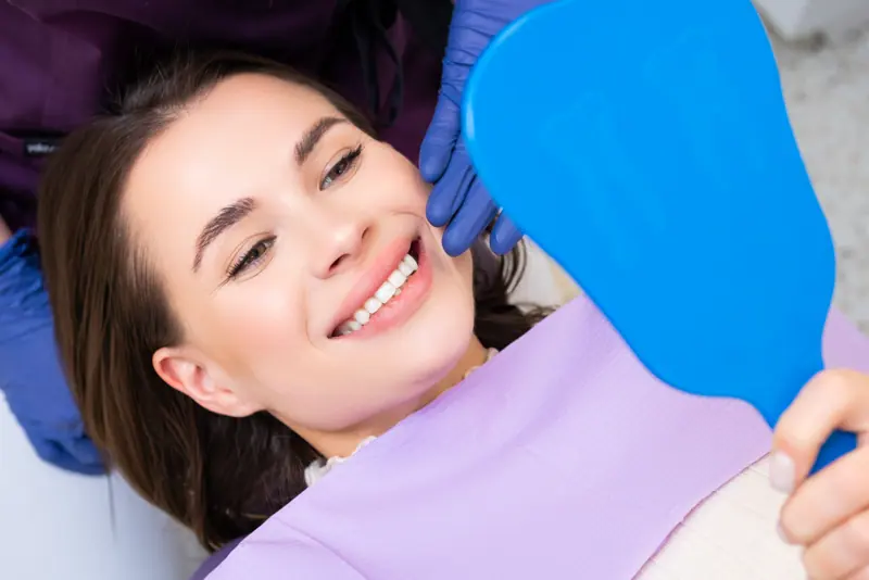 Woman smiling after dental check up procedure